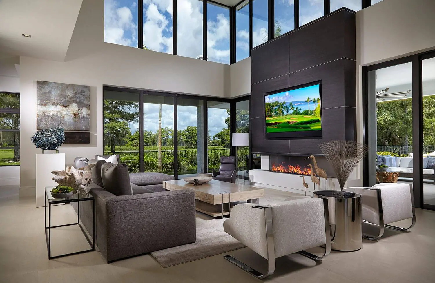 A living room with two large windows and a fireplace.