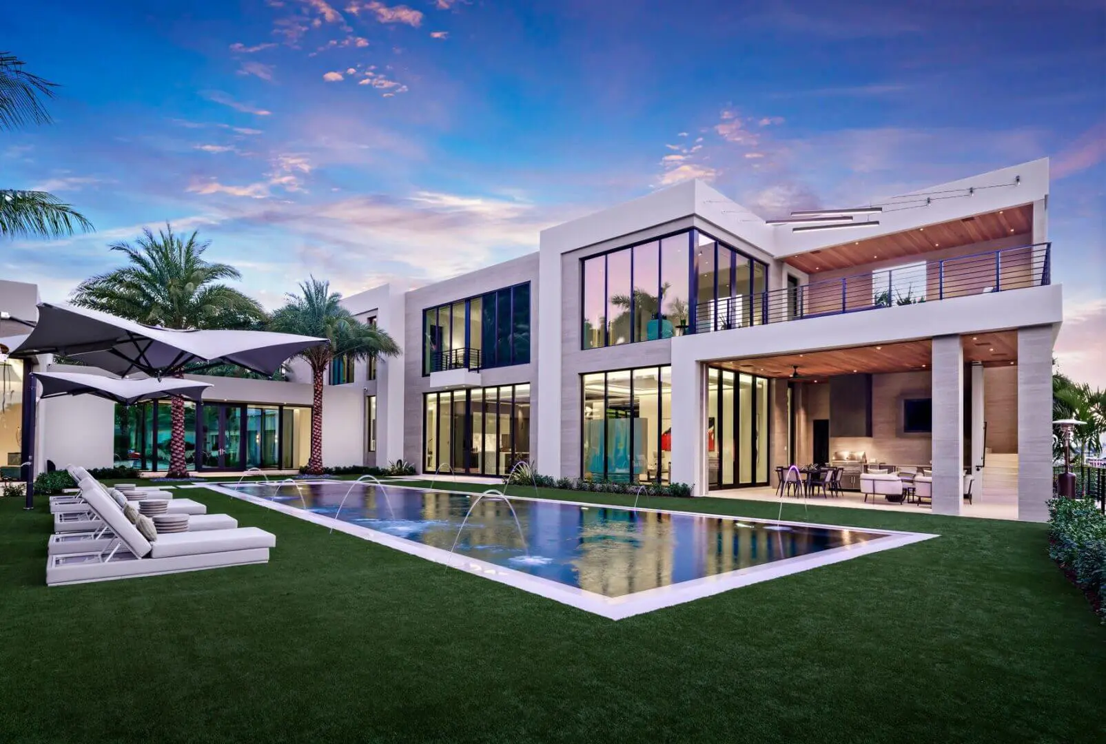 A large pool with a lot of grass around it