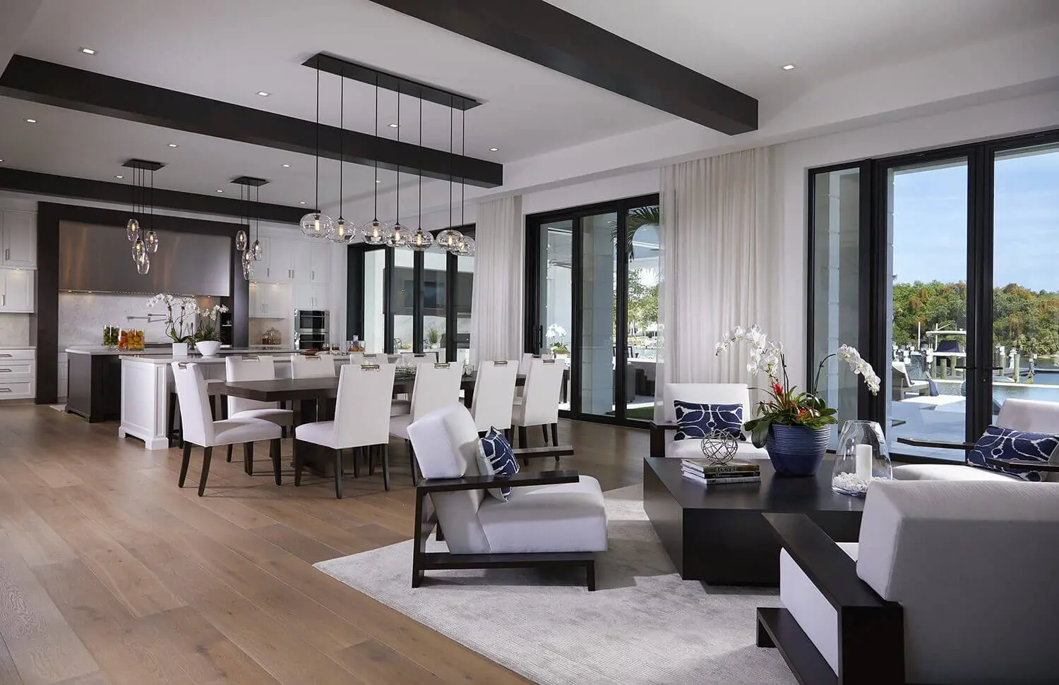 A living room with white furniture and wooden floors