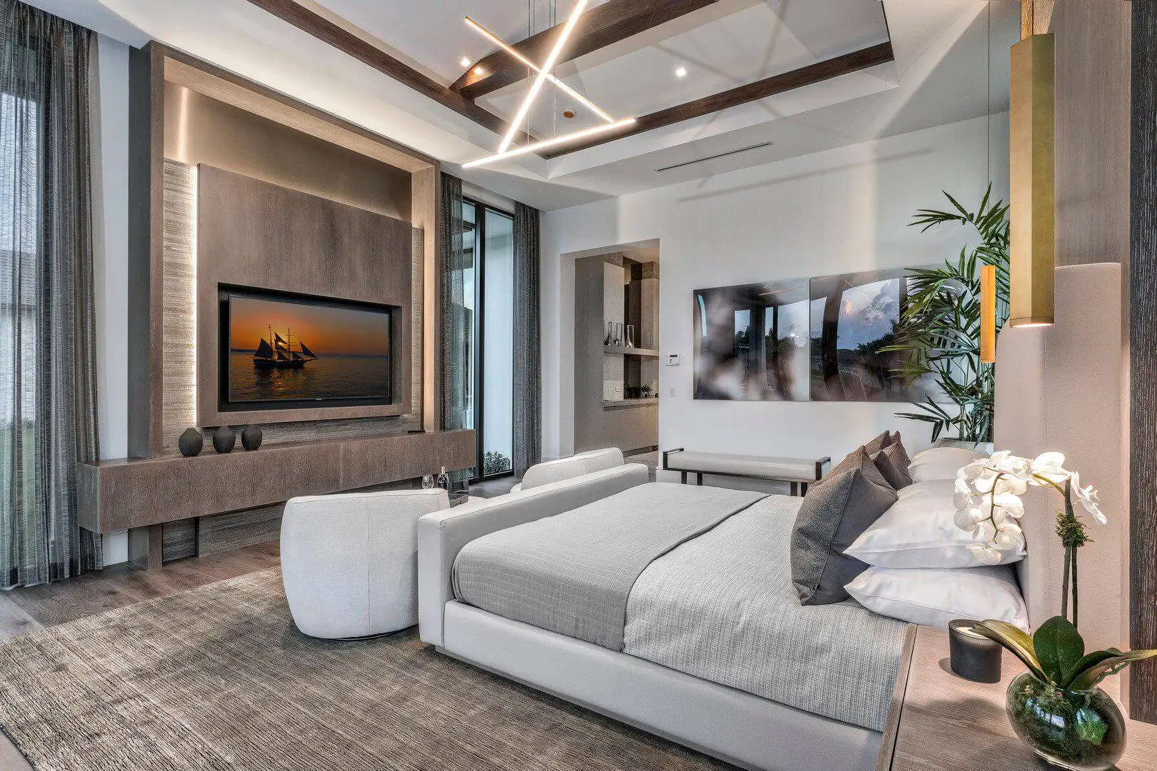 A bedroom with two beds and a television.