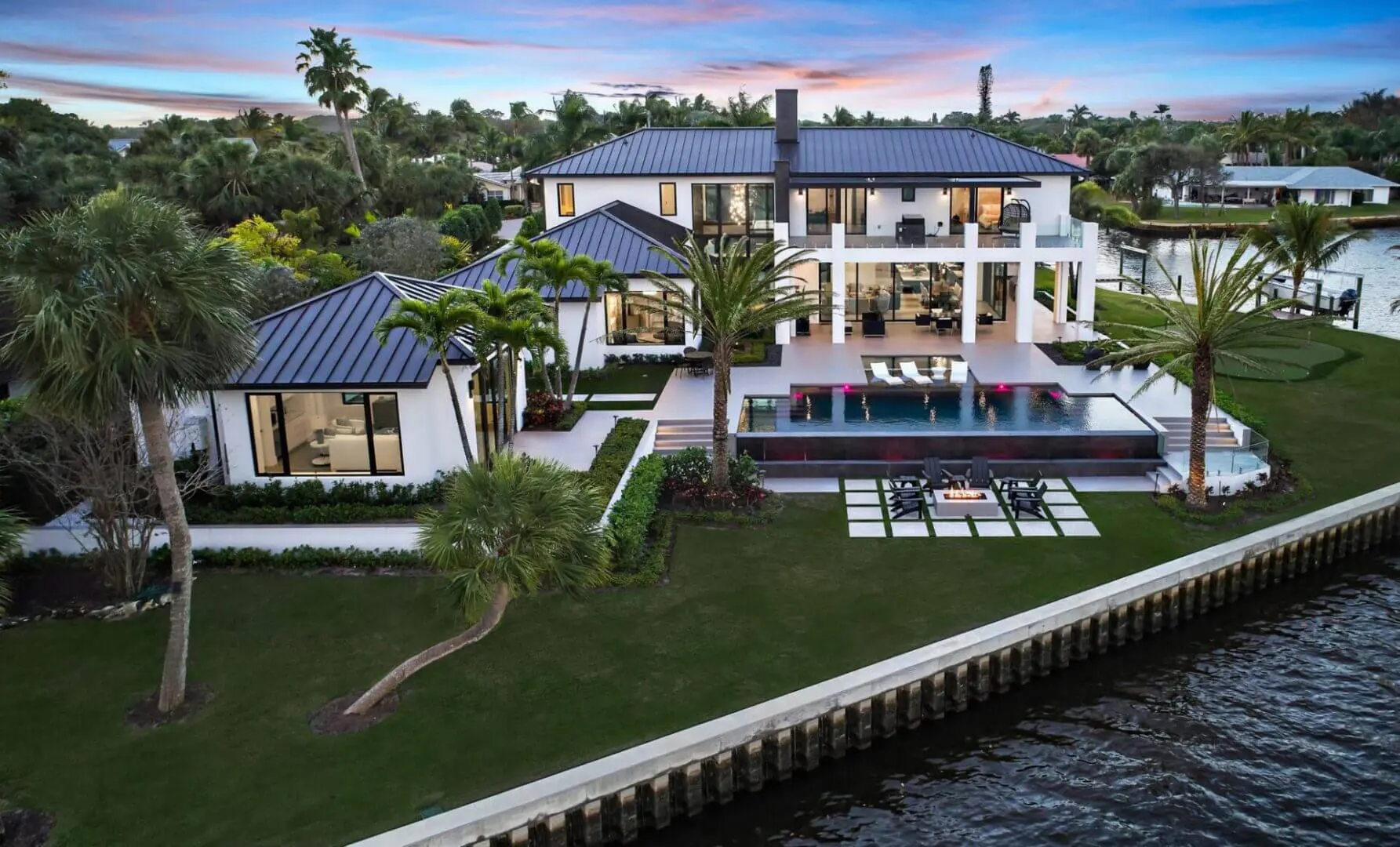 A large white house with a pool in the middle of it