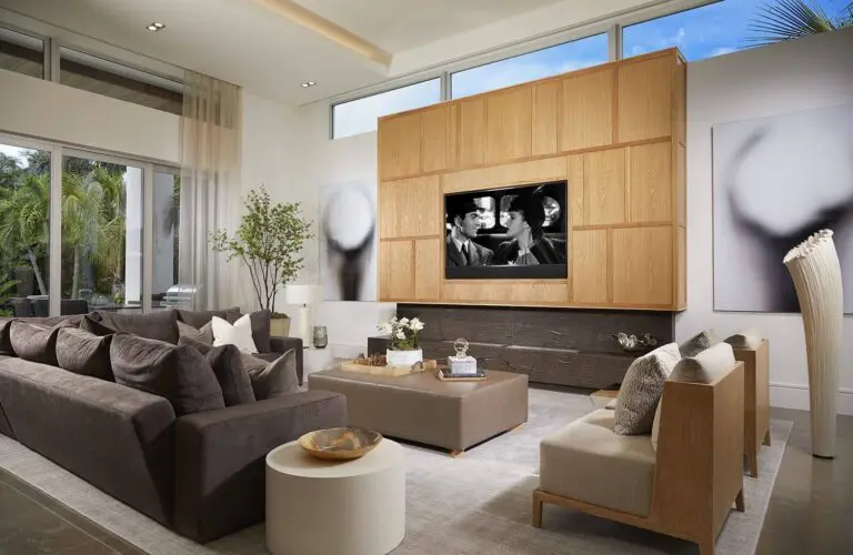 A pool with an outdoor bar and television.
