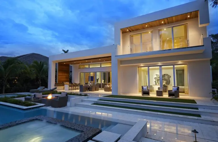 A pool with an outdoor bar and television.