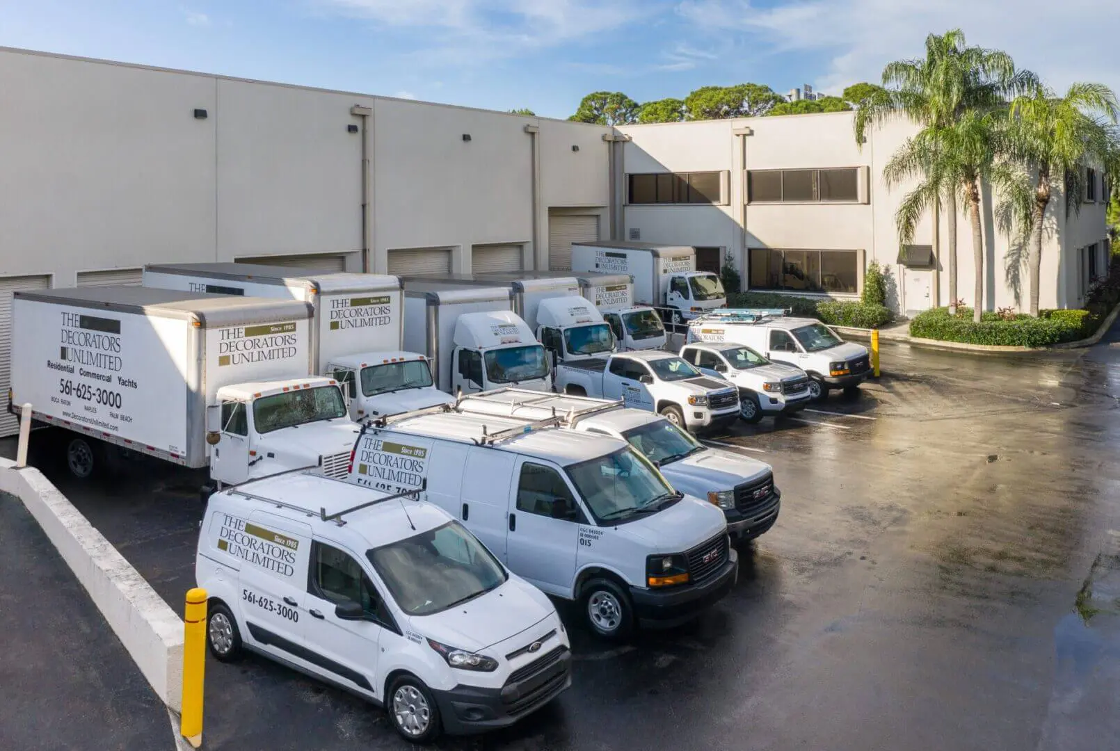 A group of vans parked in front of a building.