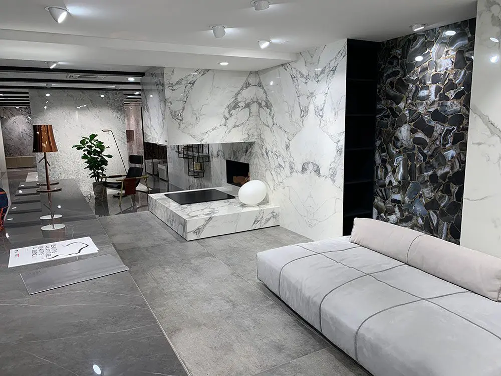 A living room with marble walls and floors
