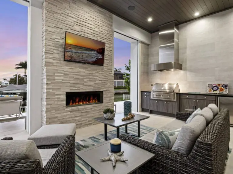 A pool with an outdoor bar and television.