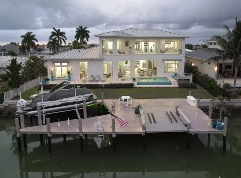 A pool with an outdoor bar and television.