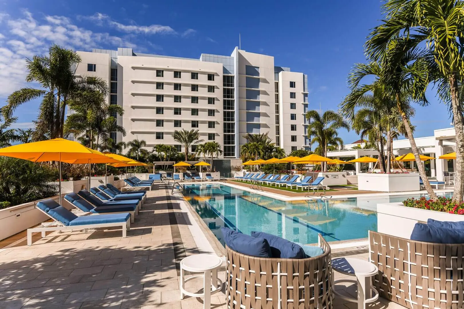A pool with chairs and umbrellas next to it