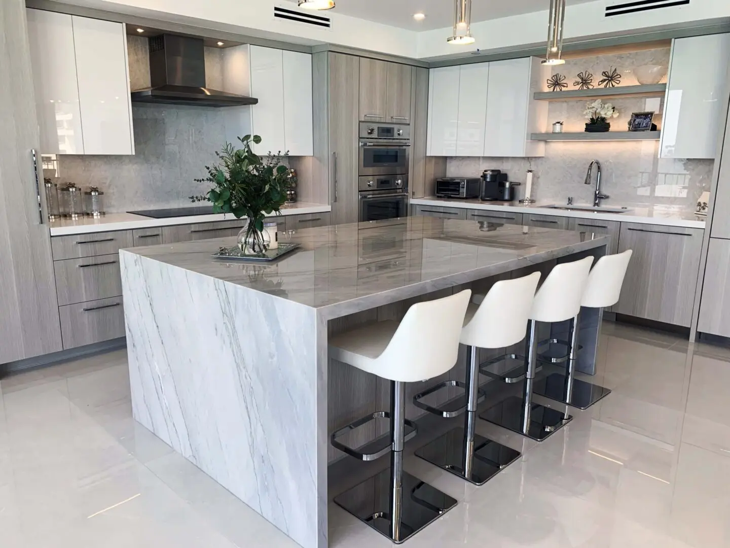 A kitchen with white cabinets and a large island.