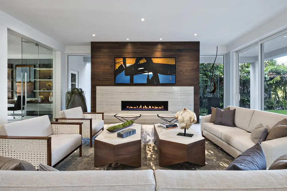 A living room with couches, chairs and tables.