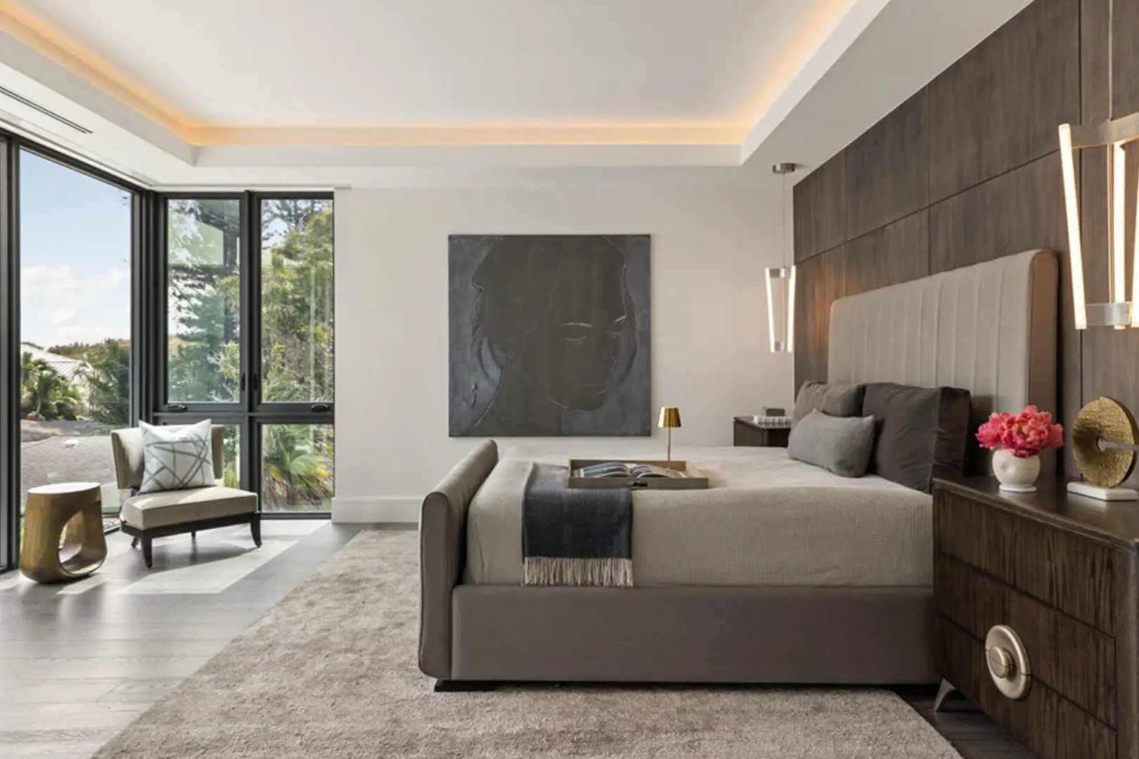 Bedroom with a large bed with pillows and a blanket on it, a tray
