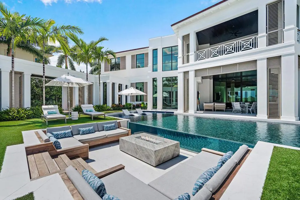Luxurious villa in Bali, Indonesia, with a large white house surrounded by lush green grass and trees