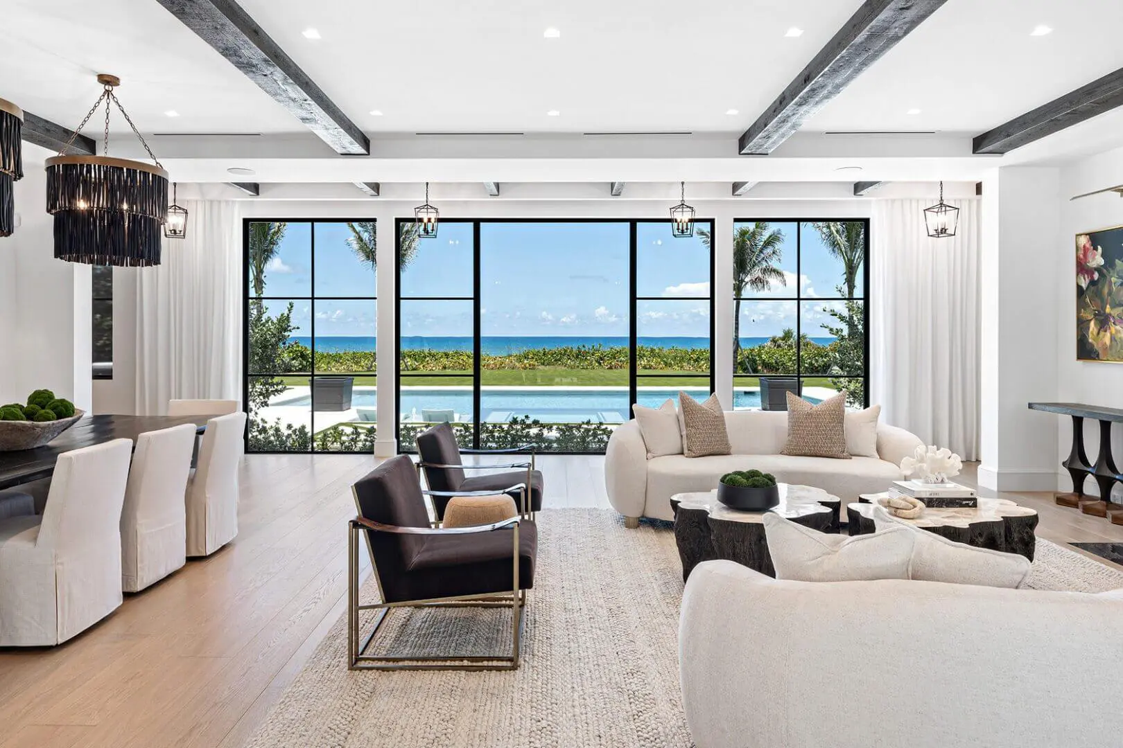 Living room filled with furniture such as a sofa set with cushions, chairs, tables, houseplants, decors