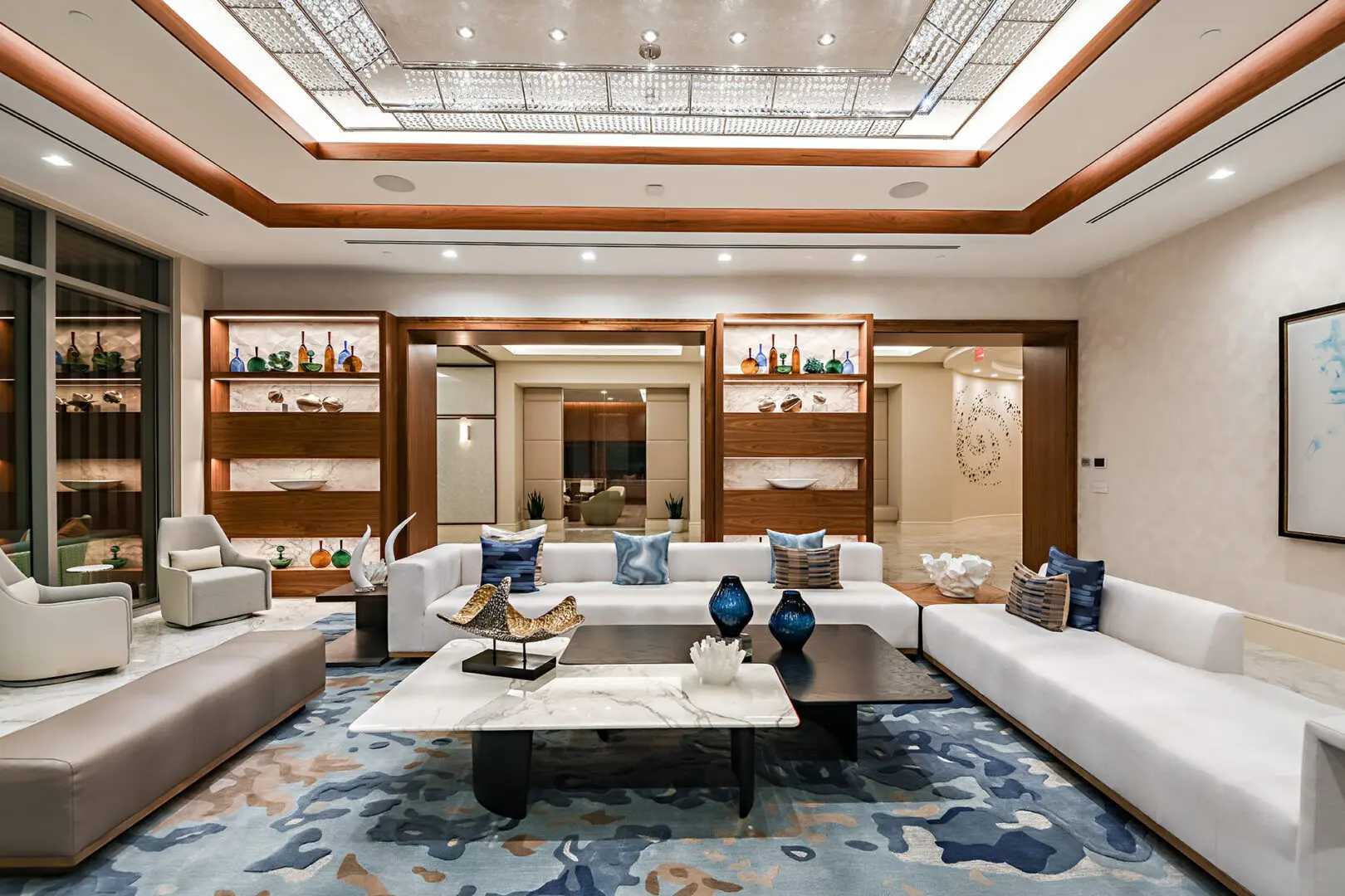 Luxurious living room with a sofa set with cushions, chairs, decors on the tables, a carpet on the floor