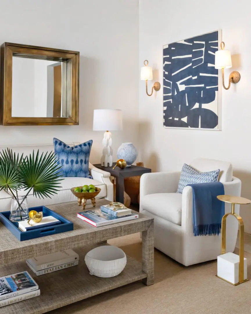 Living room with a sofa with pillows and a cloth draped over it, a table with books, a tray