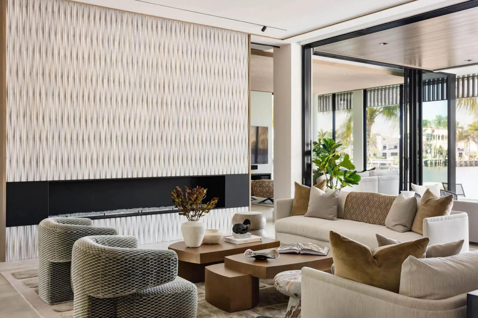 Living room with a sofa set with cushions, chairs, a carpet on the floor, a table with books