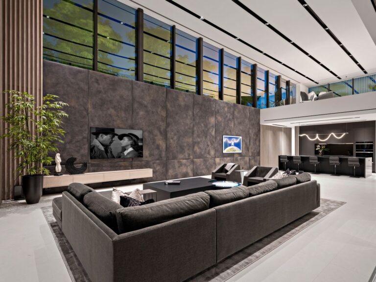 A living room with a large couch and television.