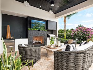 A patio with chairs, table and television.