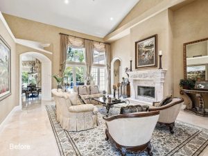 A living room with a fireplace and a large window.