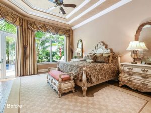 A bedroom with a bed, nightstand and window.