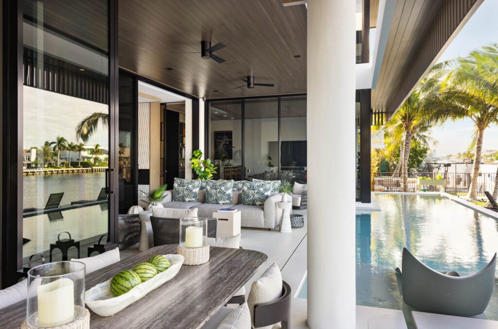 Modern patio with pool and seating area.