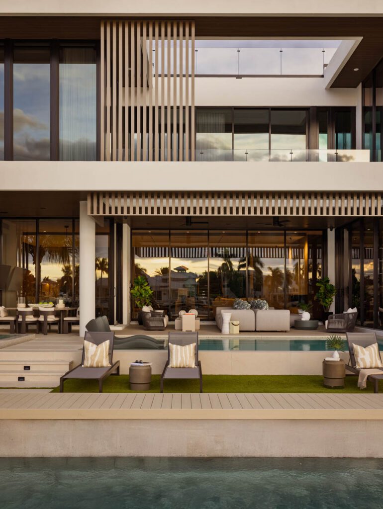 Modern house with poolside seating area.