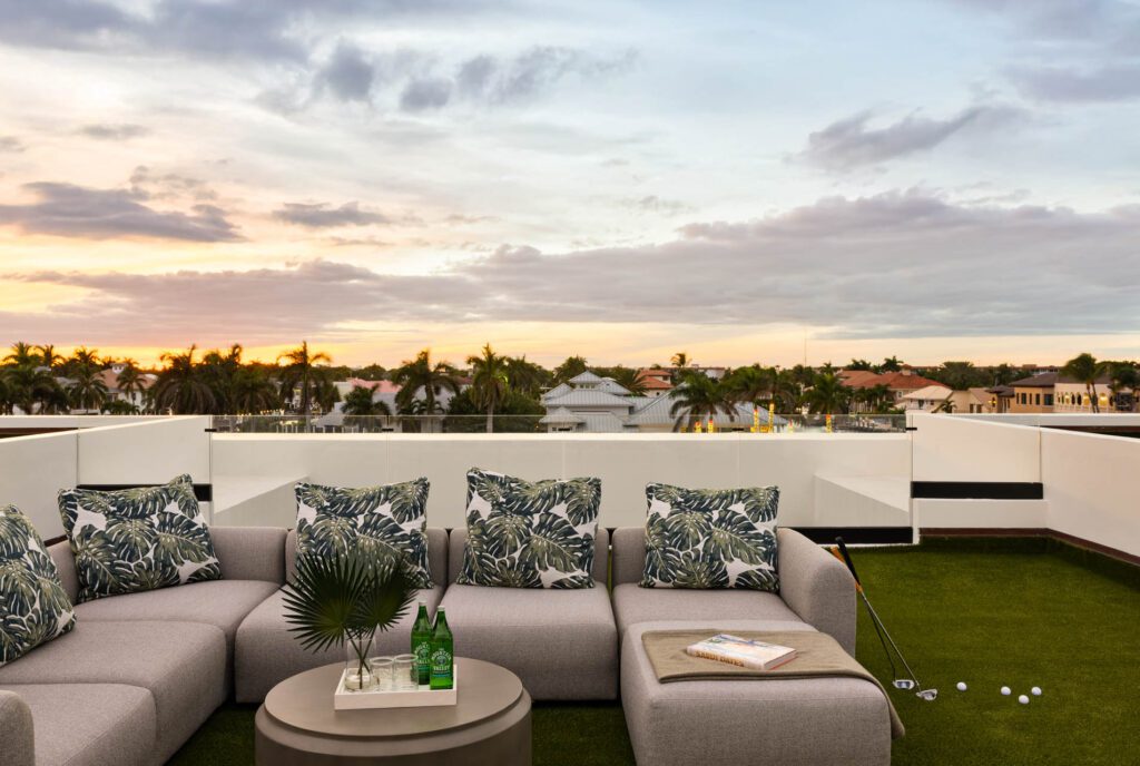 Rooftop patio with seating at sunset.