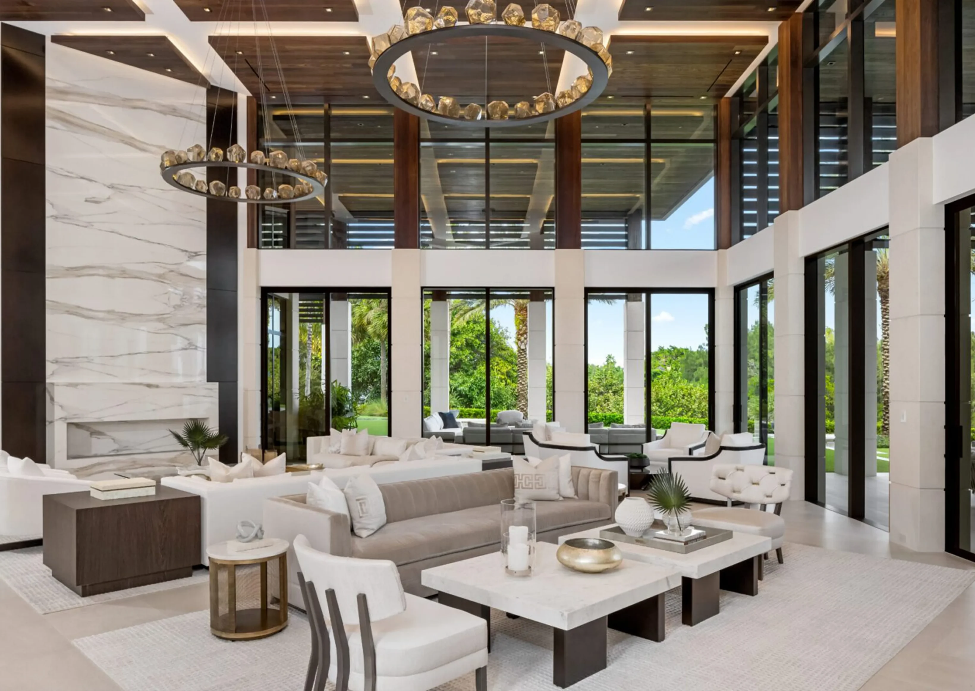 Luxurious living room with a sofa set with cushions, chairs, tables, houseplants, decors, a carpet on the floor