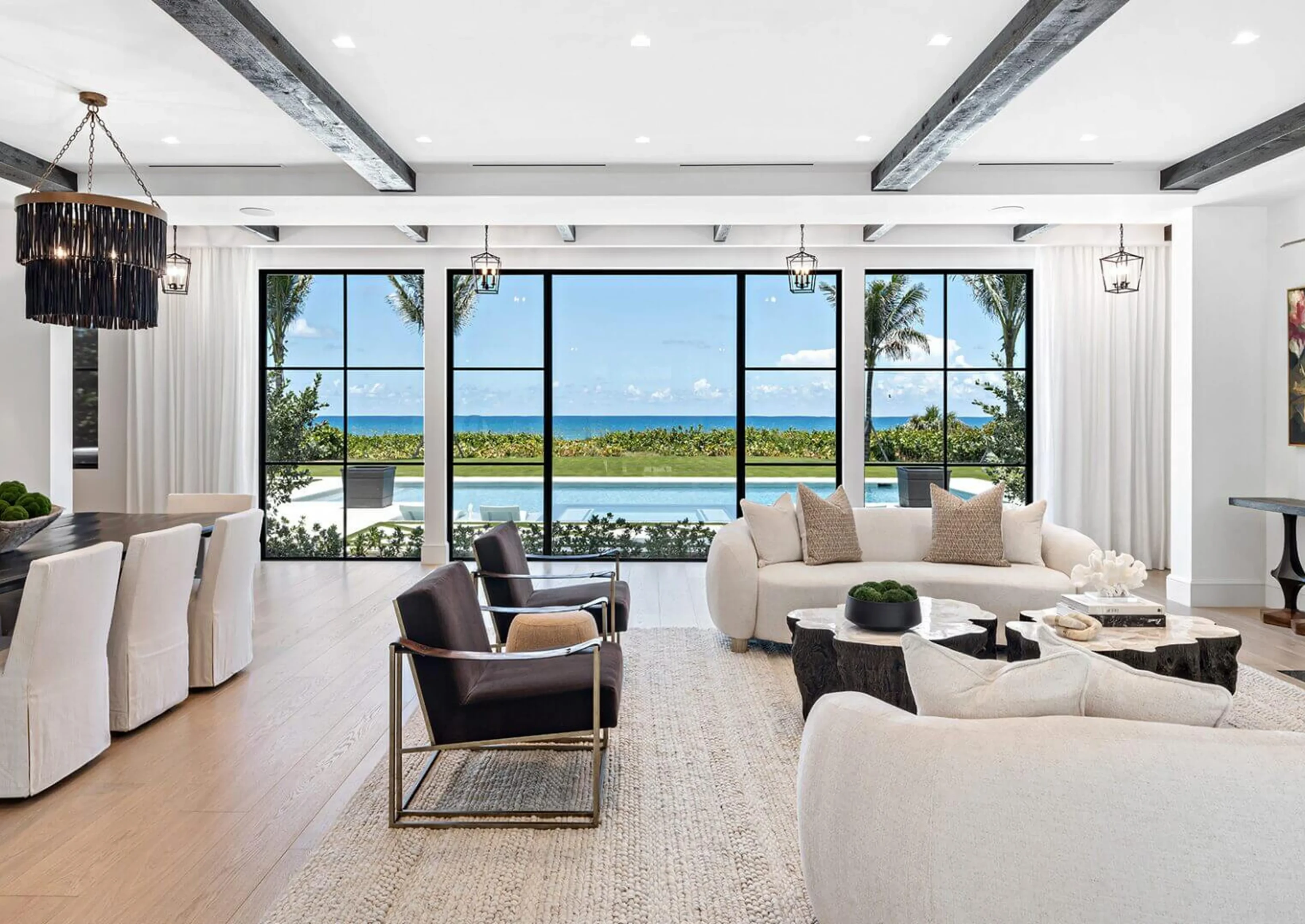 Living room filled with furniture such as a sofa set with cushions, chairs, a dining table