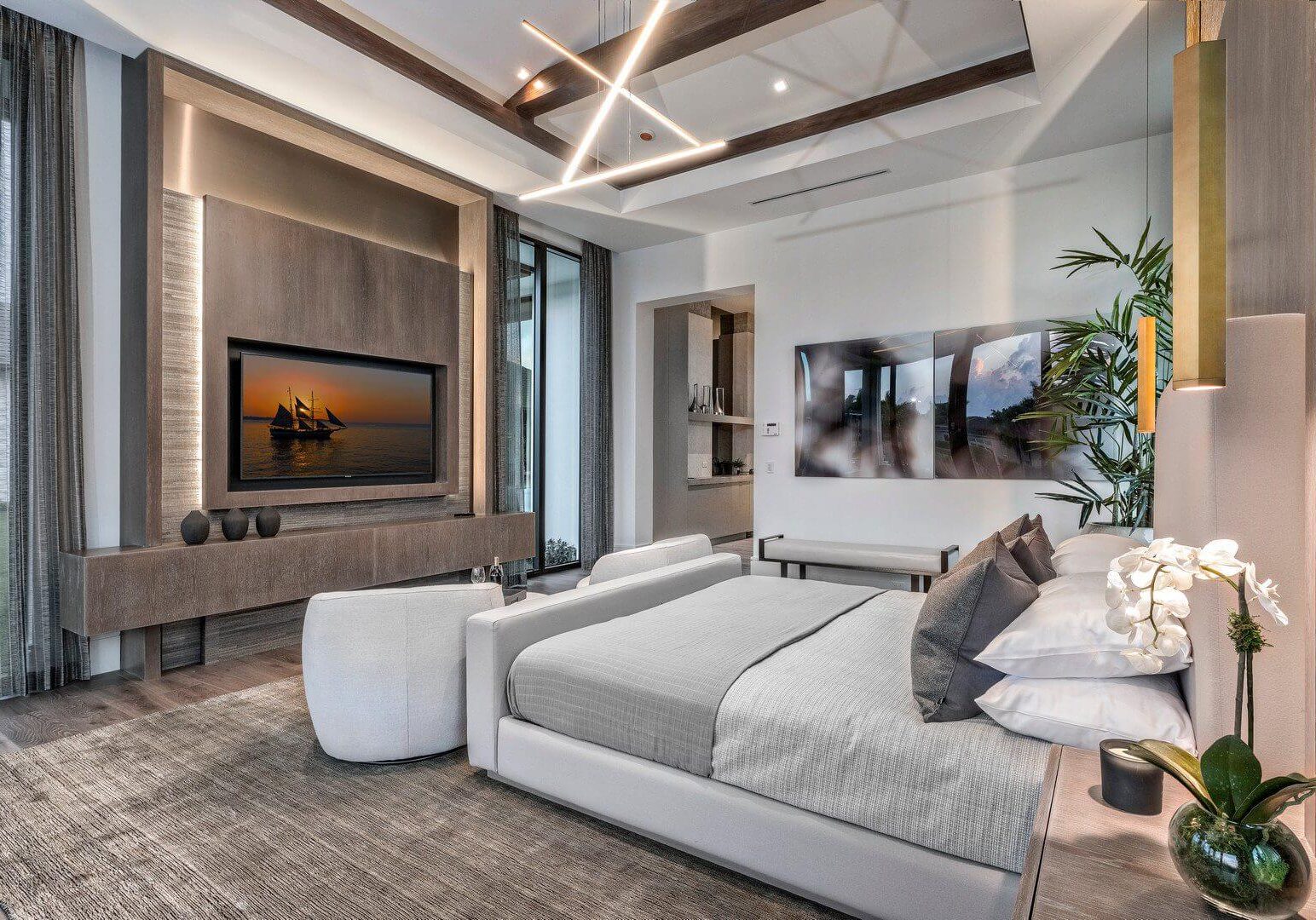 A bedroom with two beds and a television.