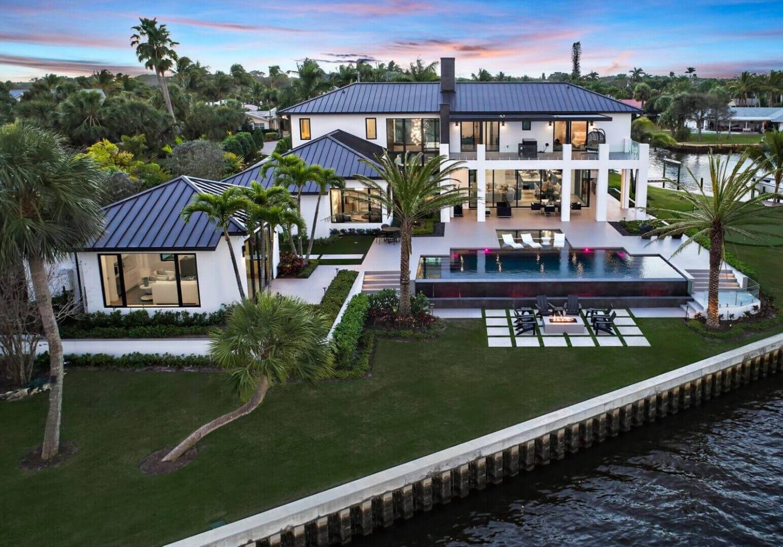 A large white house with a pool in the middle of it