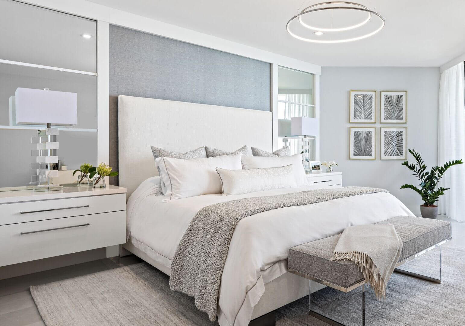 A bedroom with white furniture and grey walls