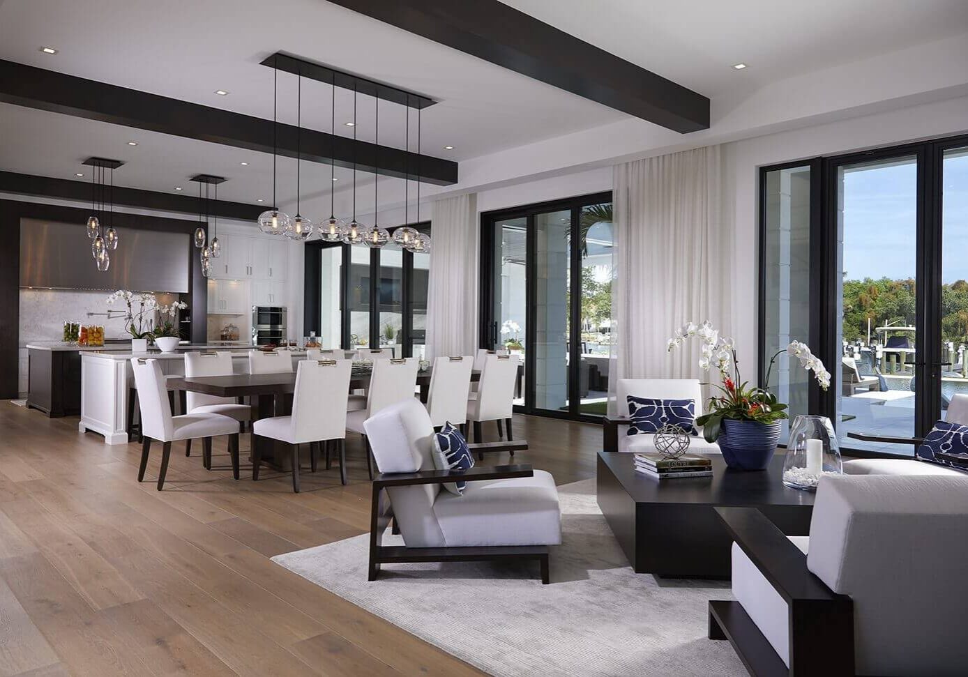 A living room with white furniture and wooden floors