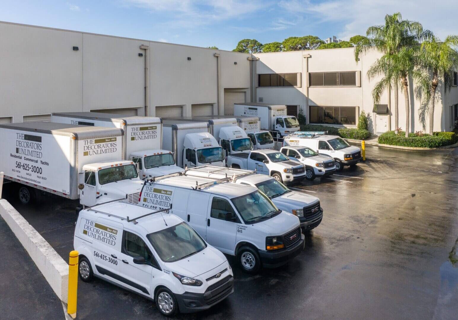 A group of vans parked in front of a building.