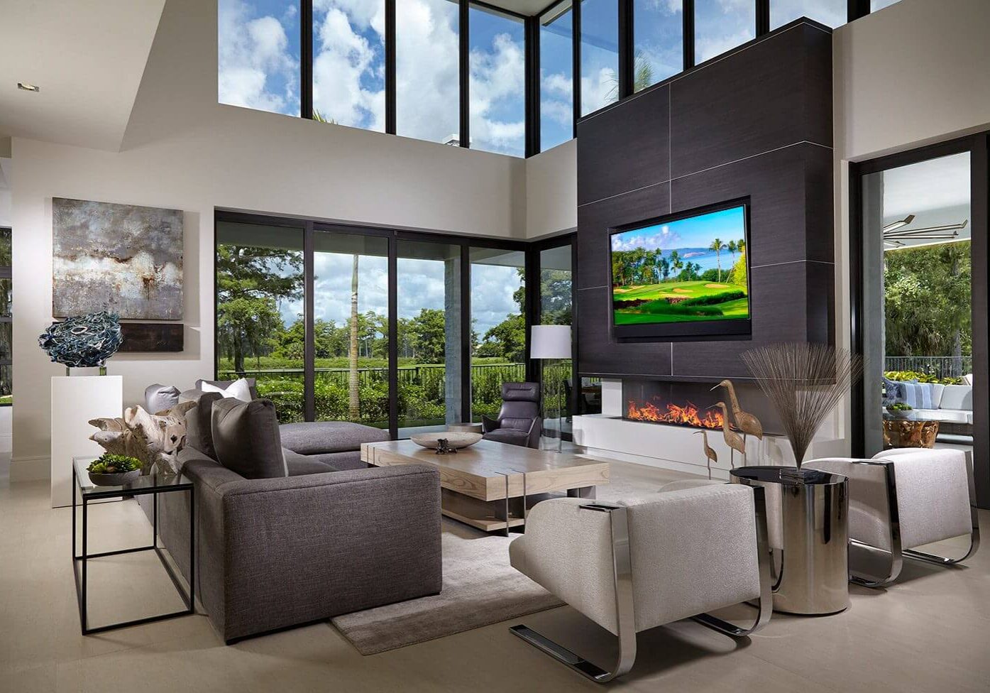 A living room with two large windows and a fireplace.