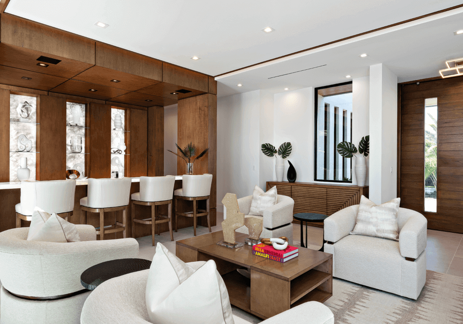 A living room with white furniture and wooden walls.