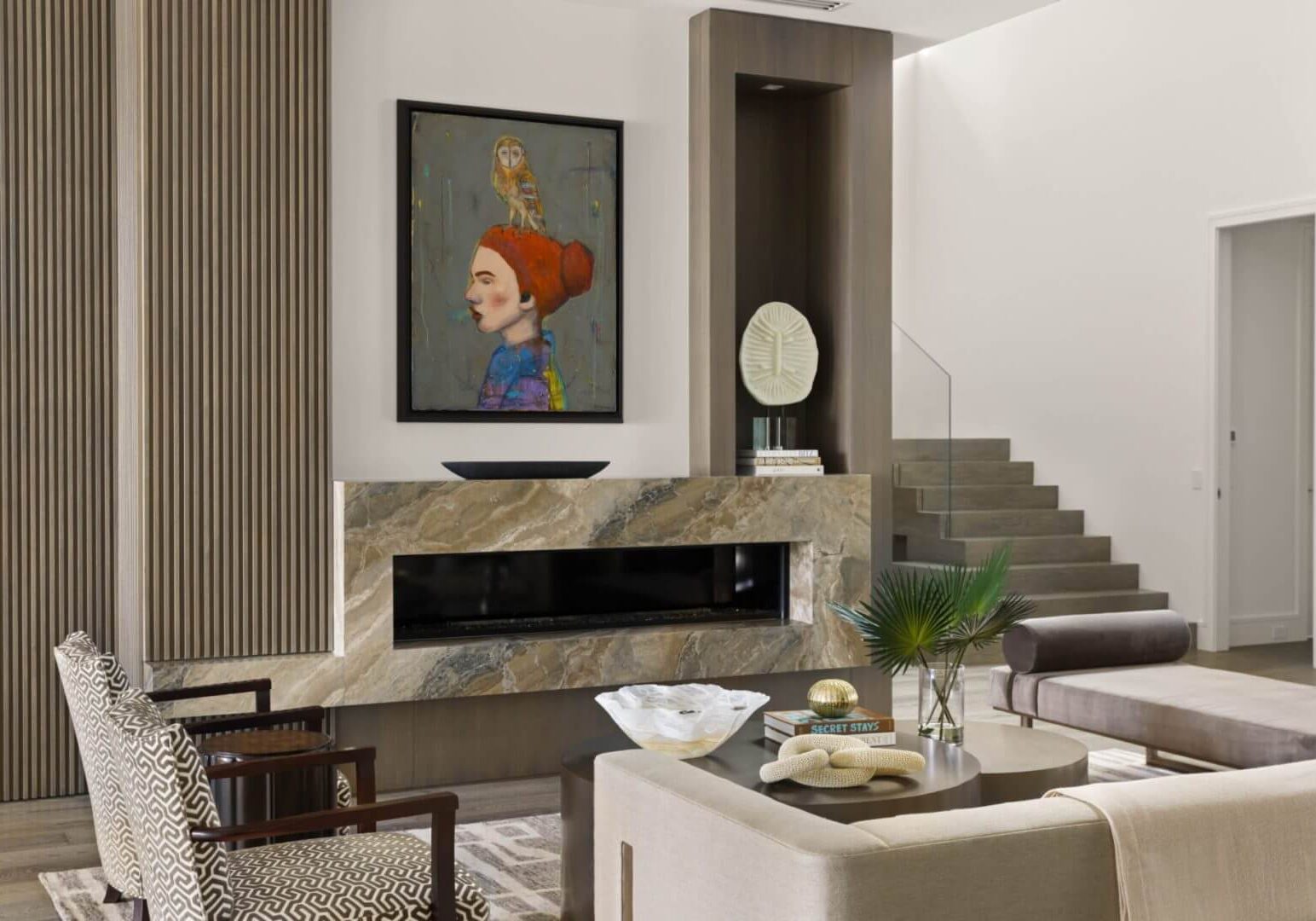 Modern living room with artwork and fireplace.