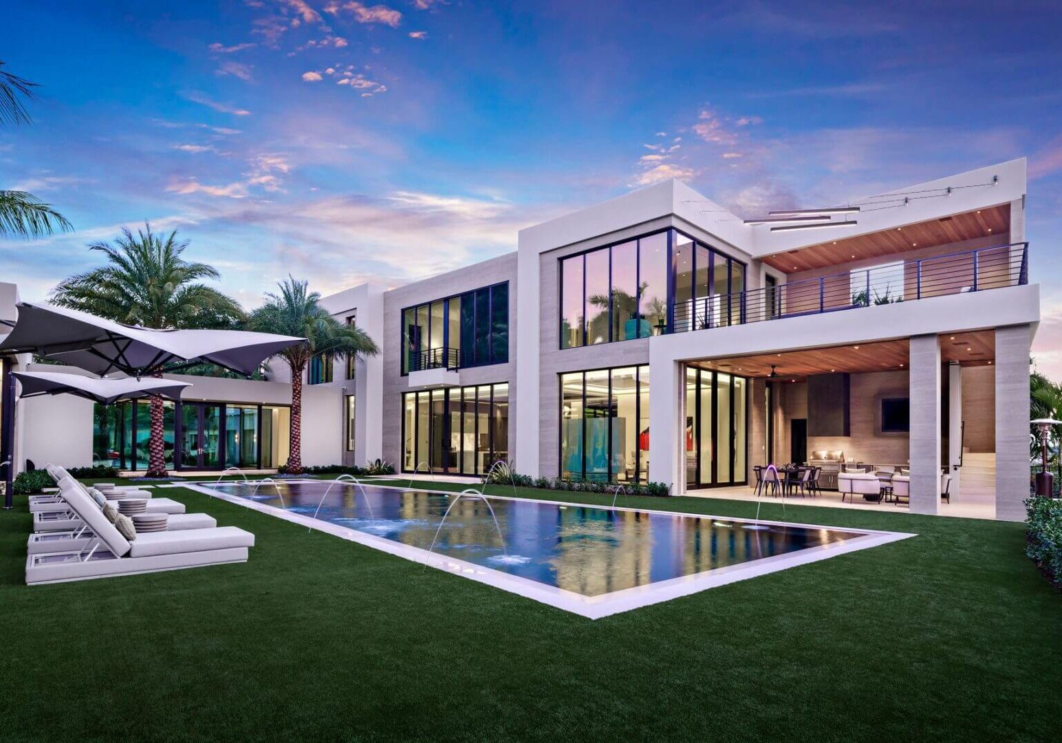 A large pool with a lot of grass around it