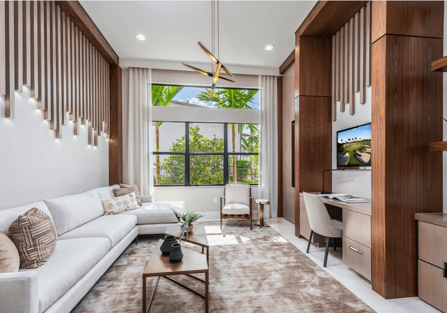 A living room with a couch, table and television.