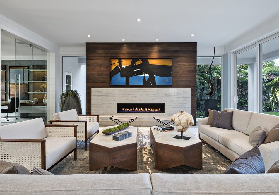A living room with couches, chairs and tables.