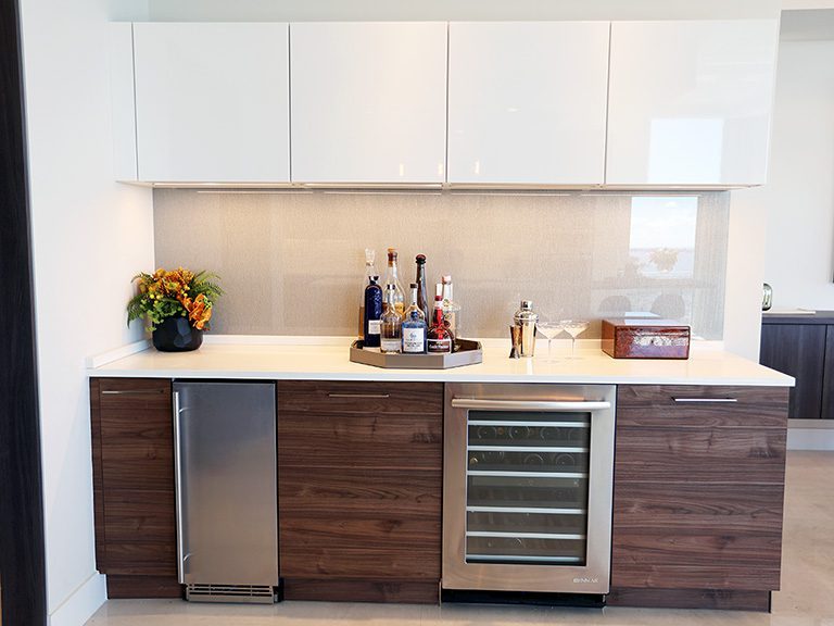 A kitchen with a wine cooler and refrigerator.
